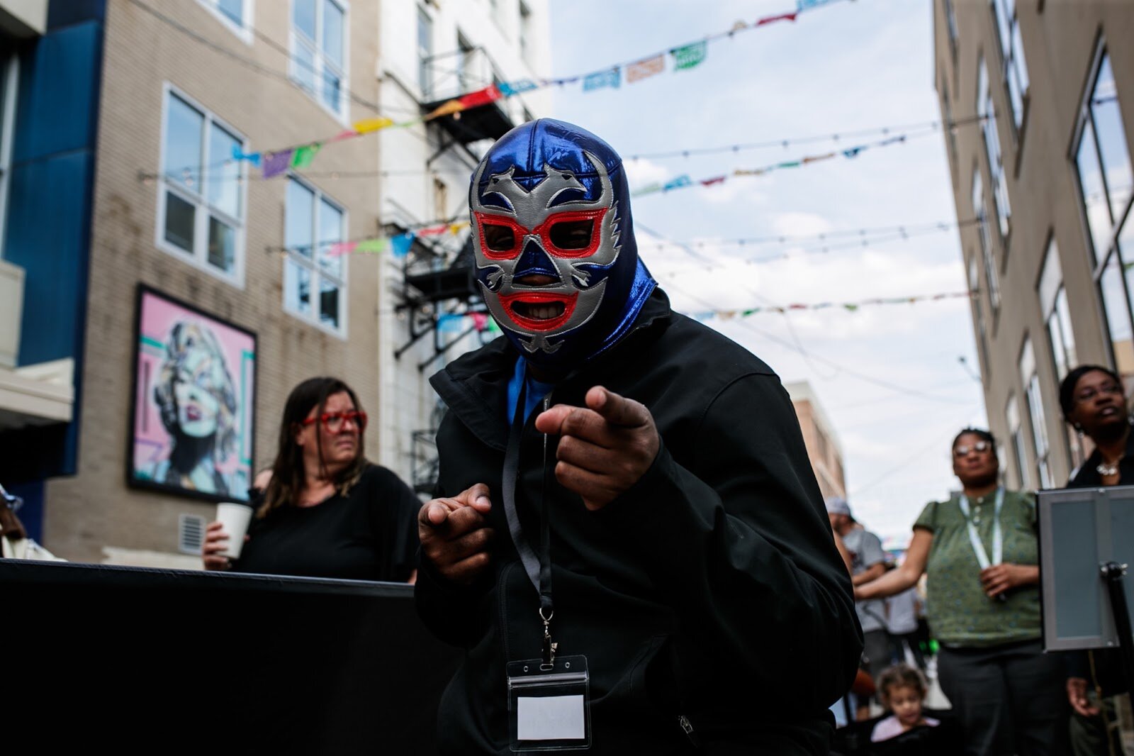 Josh Bryant, 25, an interpreter from the Latinx center poses for a portrait wearing a luchador mask during the Latinx Technology & Community Center’s Cinco de Mayo celebration on Friday, May 5, 2023, in Buckham Alley in downtown Flint. (Jenifer Veloso | Flintside)
