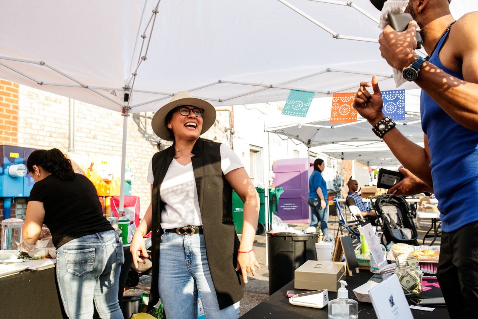Mildred Silva-Zuccaro smiles and laughs during the Latinx Technology & Community Center’s Cinco de Mayo celebration on Friday, May 5, 2023, in Buckham Alley in downtown Flint. (Jenifer Veloso | Flintside)
