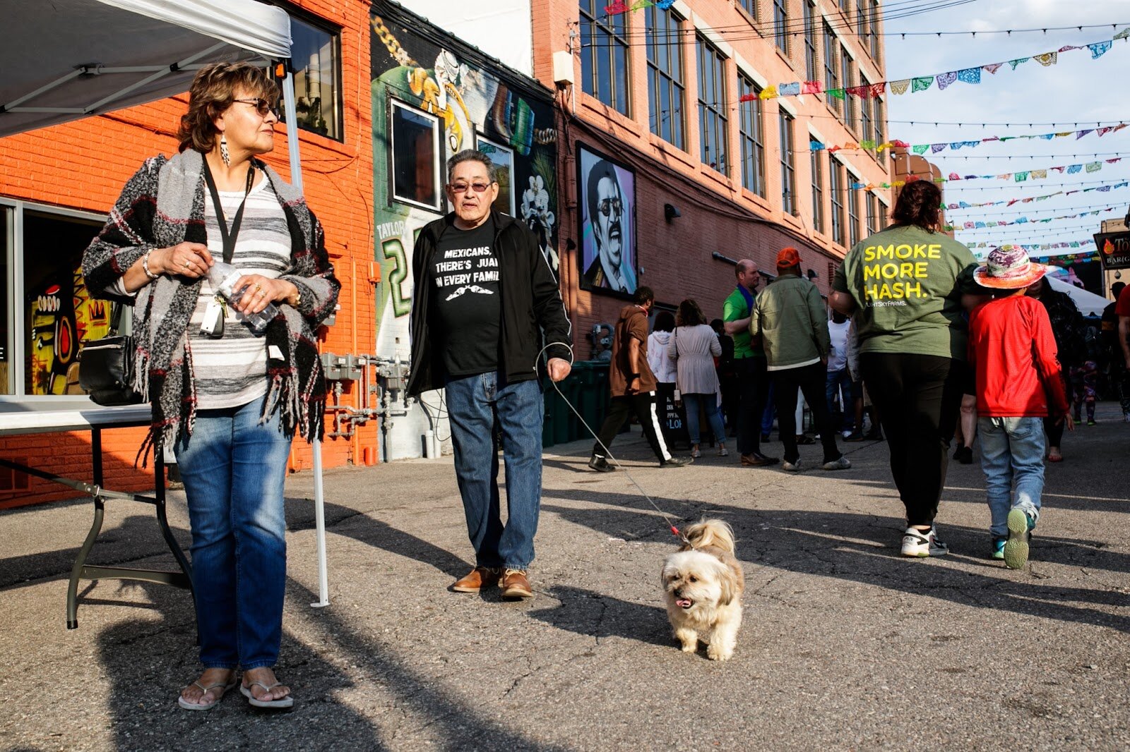 Attendants walk through the alley way during the Latinx Technology & Community Center’s Cinco de Mayo celebration on Friday, May 5, 2023, in Buckham Alley in downtown Flint. (Jenifer Veloso | Flintside)
