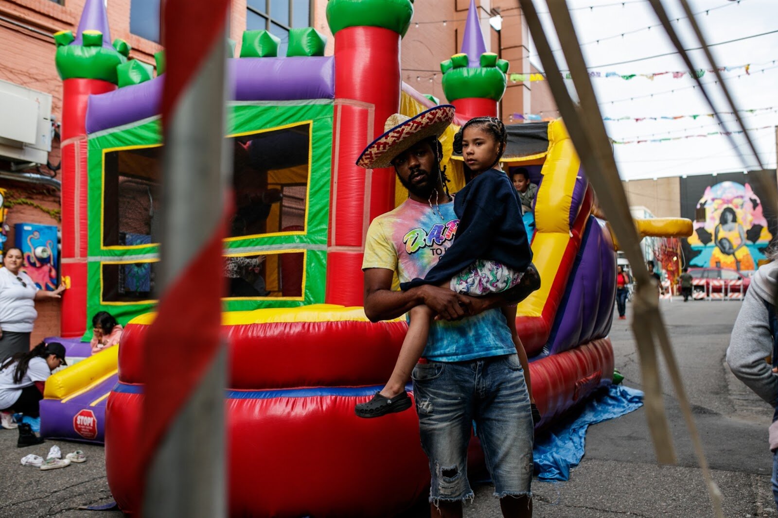An attendant walks by a play house during the Latinx Technology & Community Center’s Cinco de Mayo celebration on Friday, May 5, 2023, in Buckham Alley in downtown Flint. (Jenifer Veloso | Flintside)
