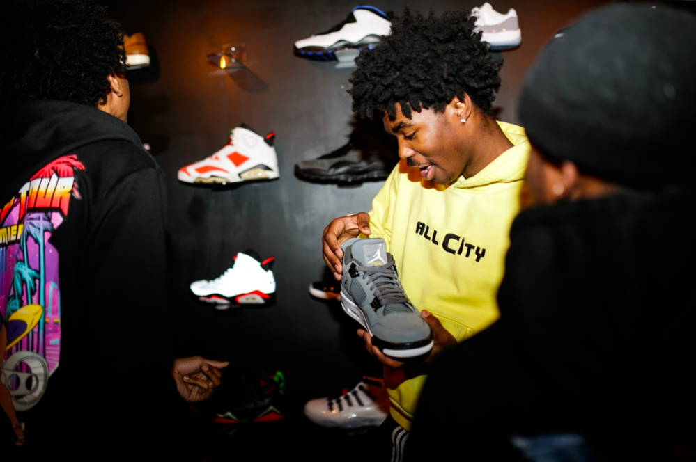 A few teens from the Boys & Girls Club check out streetwear on Tuesday, May 2, 2023, at BAU-HOUSE in downtown Flint. (Jenifer Veloso | Flintside)