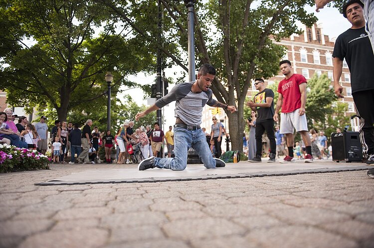 People gather to watch street performers in downtown Holland.
