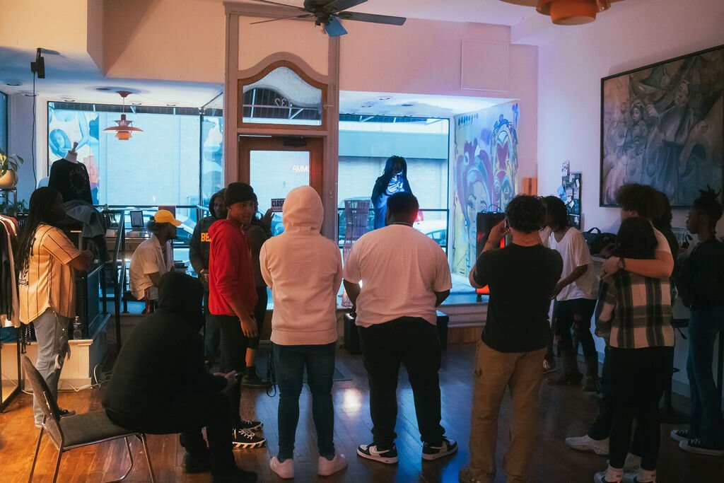 The crowd awaits the next performance during Open Mic Night at Comma Bookstore & Social Hub on Friday, April 7, 2023. (Mike Powell | Flintside)