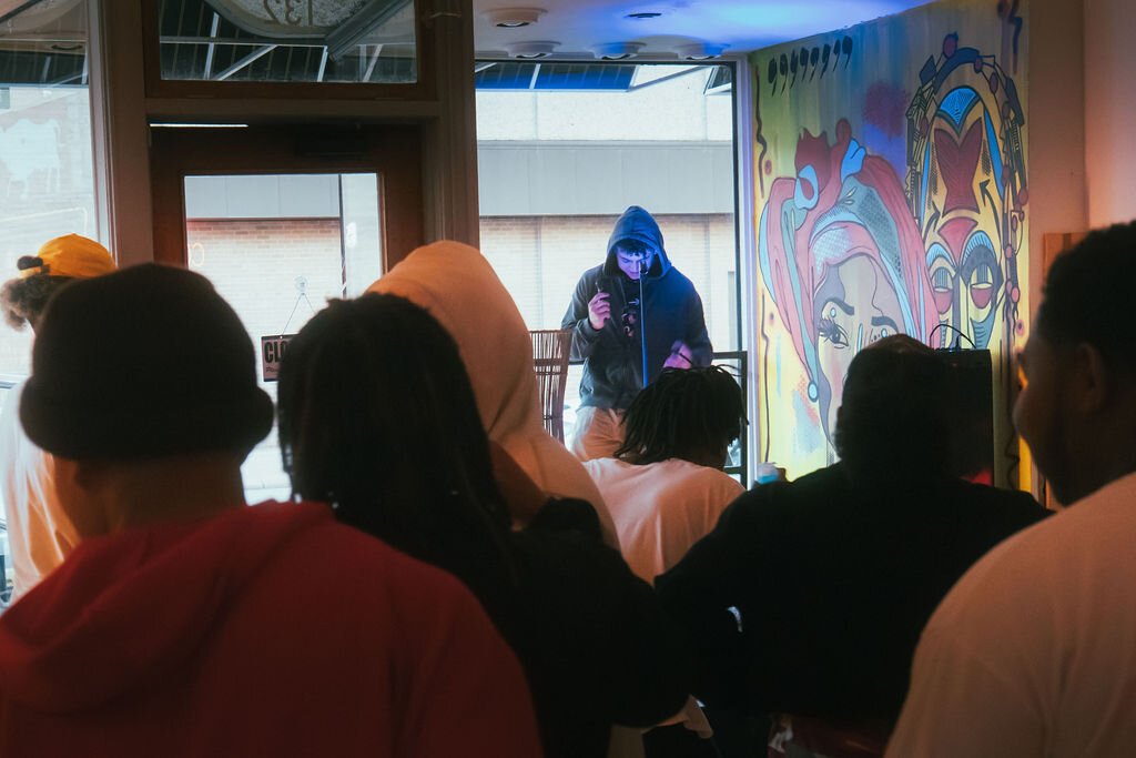 Local artist performs during Open Mic Night at Comma Bookstore & Social Hub on Friday, April 7, 2023. (Mike Powell | Flintside)