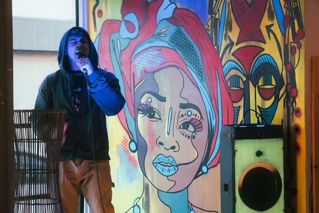 Local artist performs during Open Mic Night at Comma Bookstore & Social Hub on Friday, April 7, 2023. (Mike Powell | Flintside)