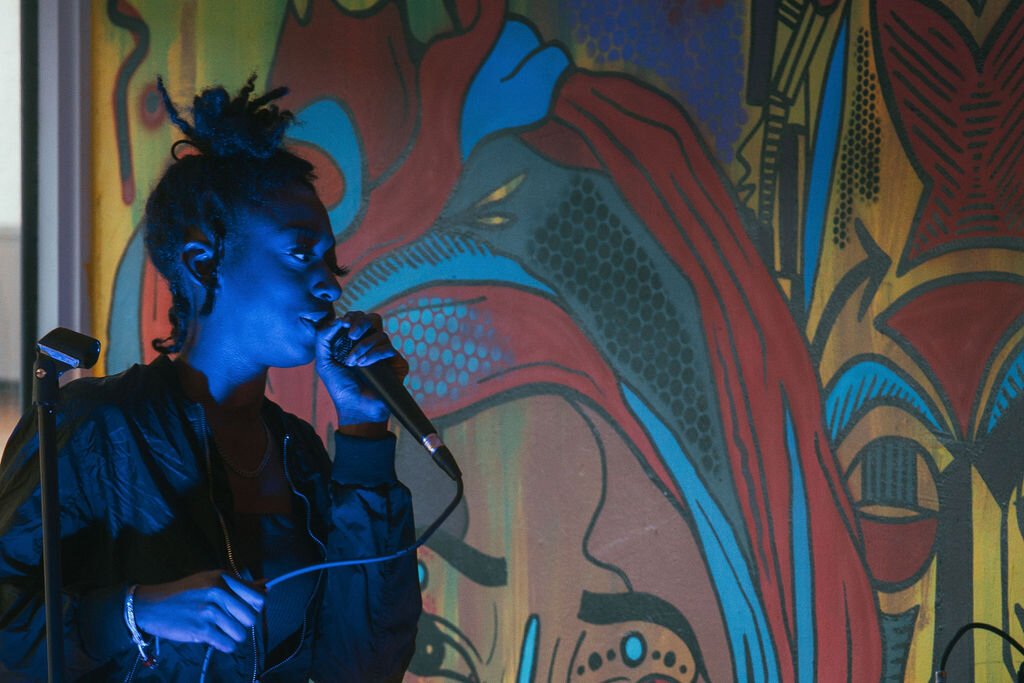 Local artist performs during Open Mic Night at Comma Bookstore & Social Hub on Friday, April 7, 2023. (Mike Powell | Flintside)