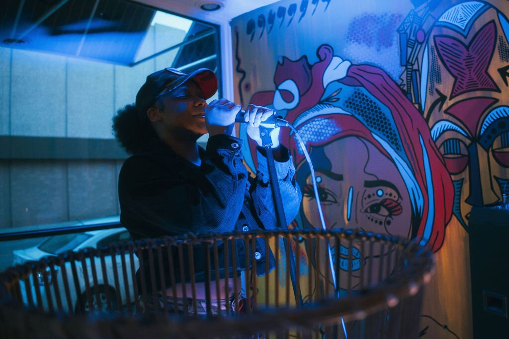 Local artist performs during Open Mic Night at Comma Bookstore & Social Hub on Friday, April 7, 2023. (Mike Powell | Flintside)