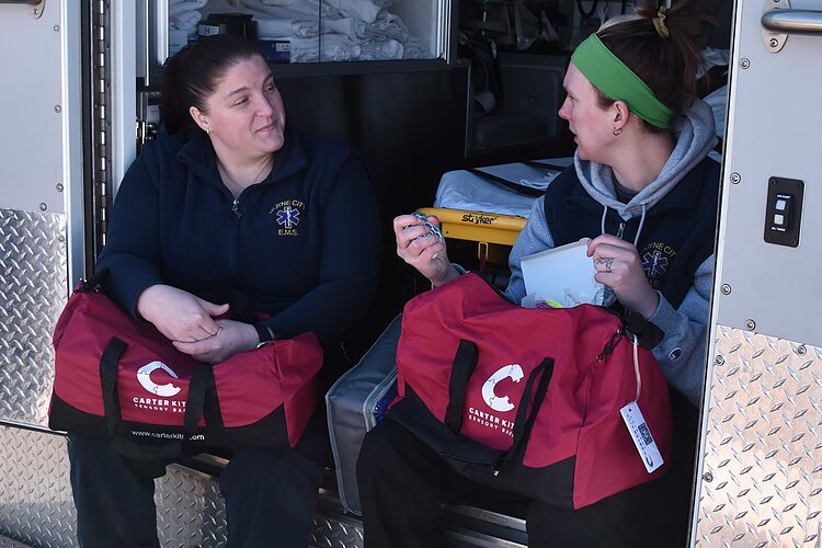 Paramedic and EMS director Brenda Willson, left, talks Carter Kits with EMT Jamie Dean, right.