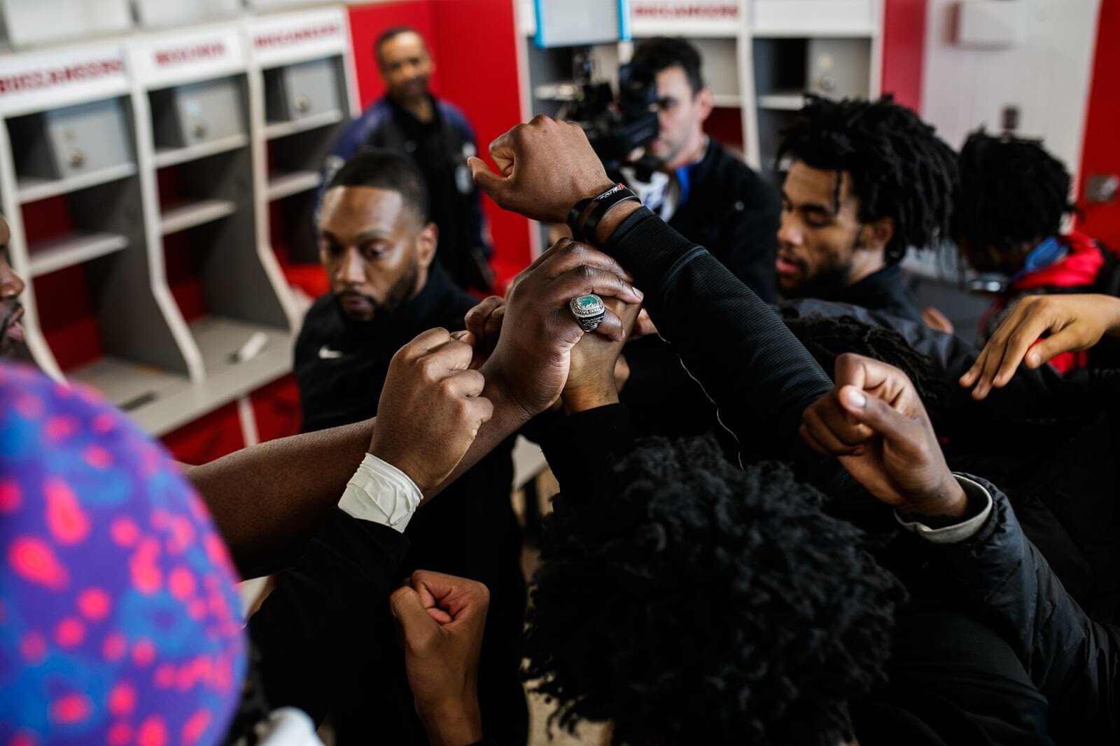 Beecher varsity boys hold their firsts together after the boys' varsity basketball game on Saturday, Feb. 18, 2023, at the Moses Lacey Fieldhouse in Mount Morris. Beecher defeated Hamady 48-43 (Jenifer Veloso | Flintside)

