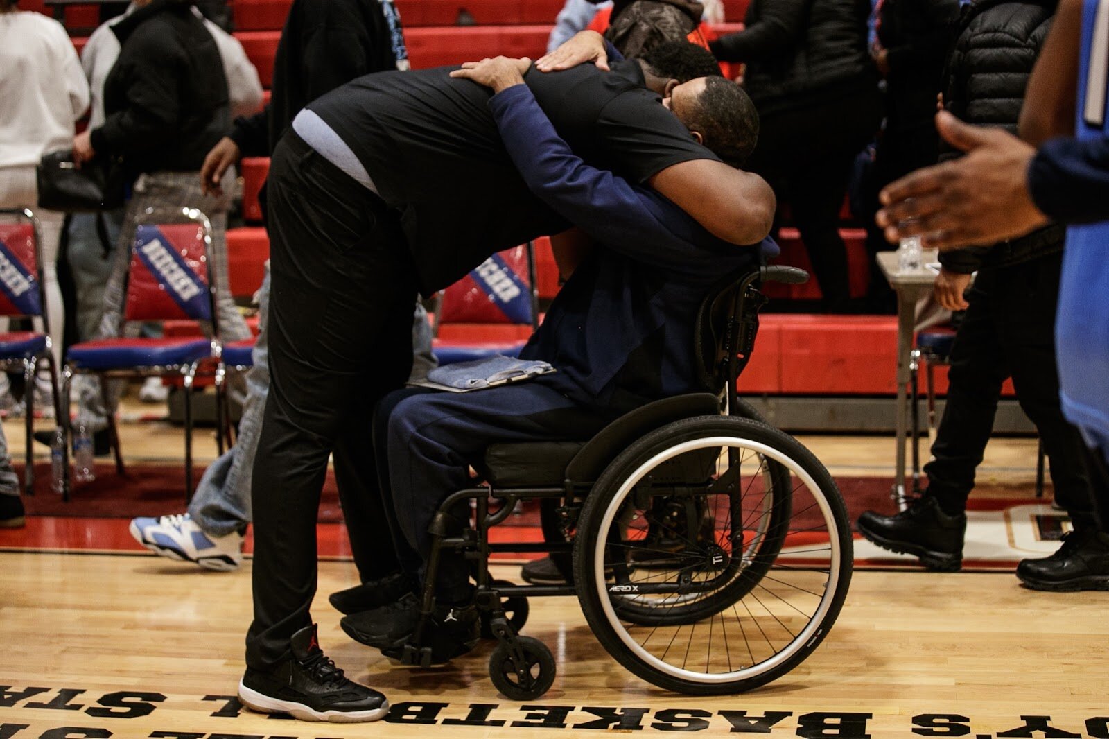 Beecher Head Coach Marquise Gray hugs a Hamady assistant coach at the end of the boys' varsity basketball game on Saturday, Feb. 18, 2023, at the Moses Lacey Fieldhouse in Mount Morris. Beecher defeated Hamady 48-43 (Jenifer Veloso | Flintside)
