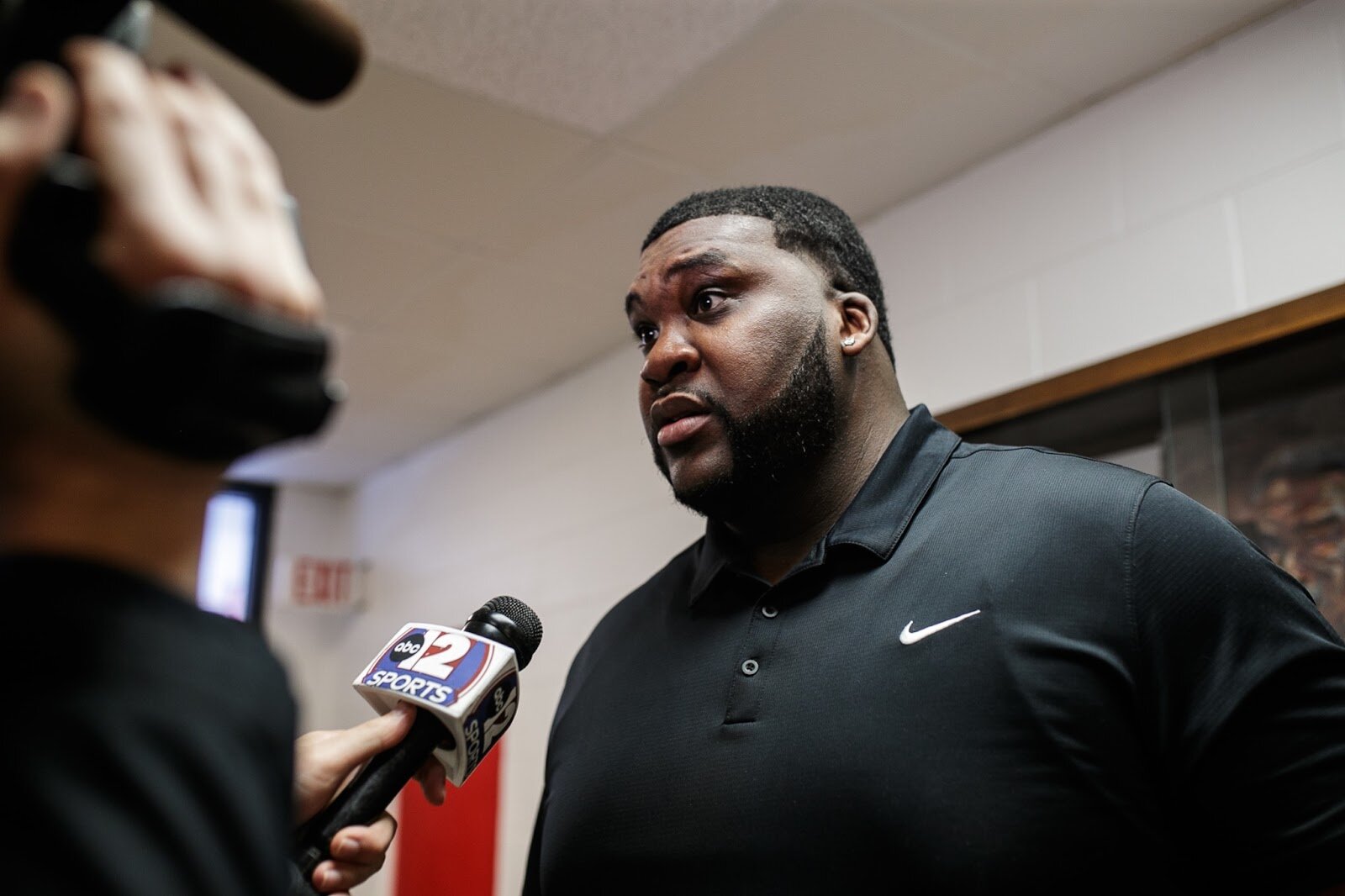 Beecher Head Coach Marquise Gray talks to the press after the boys' varsity basketball game on Saturday, Feb. 18, 2023, at the Moses Lacey Fieldhouse in Mount Morris. Beecher defeated Hamady 48-43. (Jenifer Veloso | Flintside)
