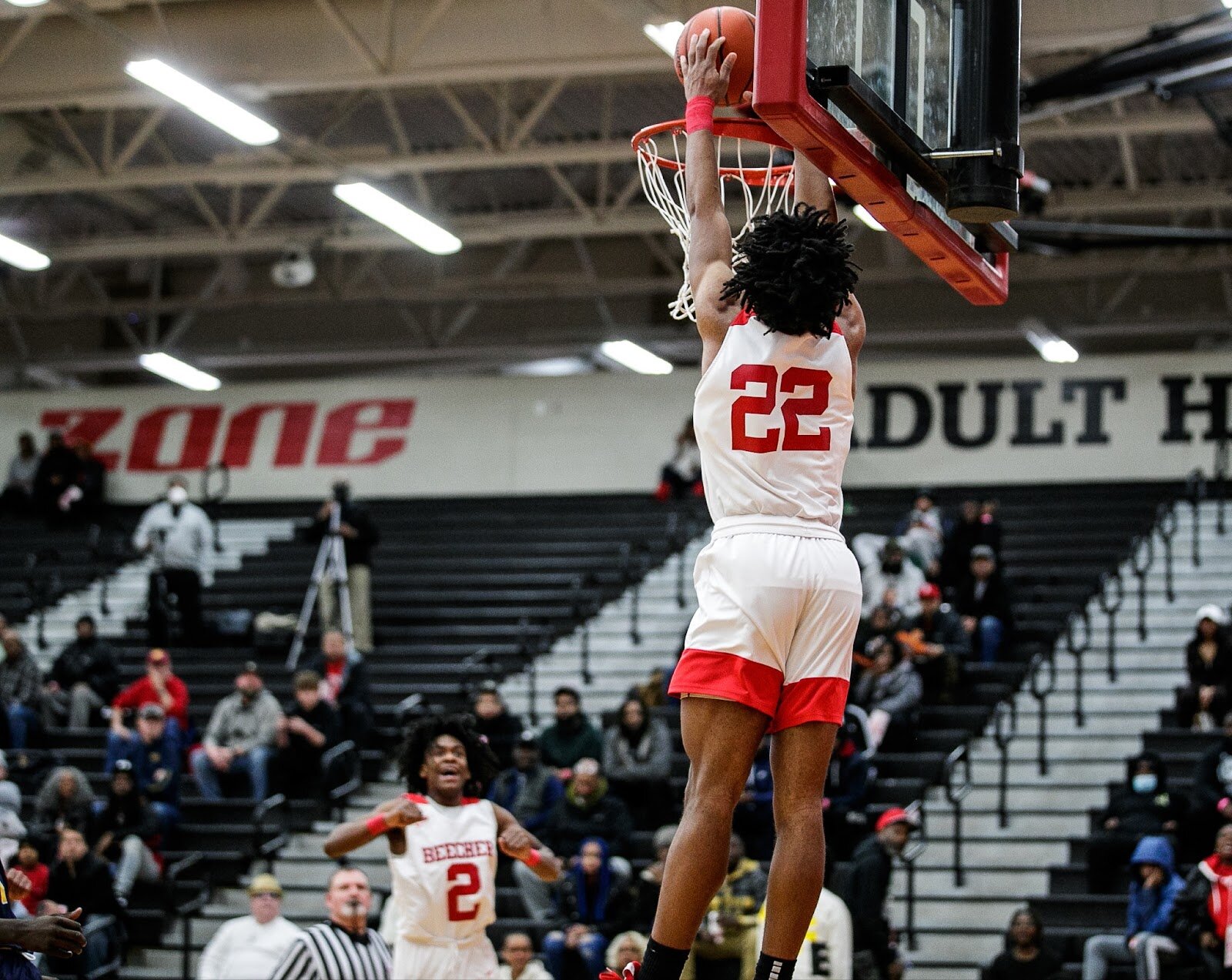 Beecher senior Robert Lee Jr. dunks as junior Keyonta Minefield cheers Lee on during the Beecher vs Saginaw Arthur Hill game at Grand Blanc High School for The Carmody Classic on Saturday, Jan. 07, 2022. Beecher defeated Arthur Hill 77-44 (Jenifer Veloso | Flintside)
