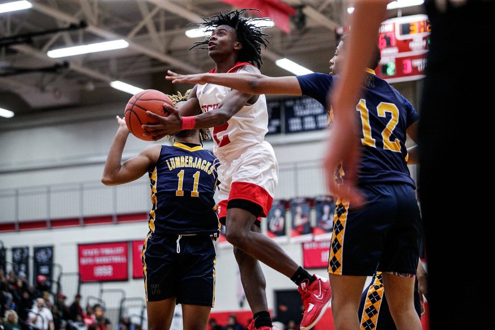 Beecher junior Keyonta Menefield drives through Arthur Hill defenders during the Beecher vs Saginaw Arthur Hill game at Grand Blanc High School for The Carmody Classic on Saturday, Jan. 07, 2022. Beecher defeated Arthur Hill 77-44 (Jenifer Veloso | Flintside)

