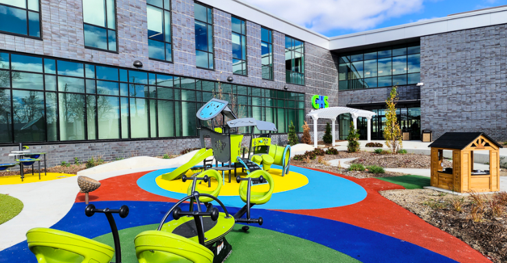 A playground sits outside of the new building.