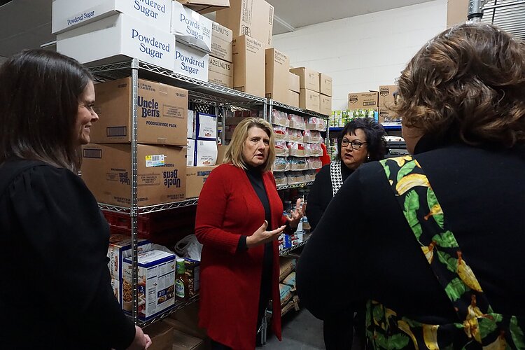 Tina Swanton, MiHIA executive director of community impact and strategic partnerships; MiHIA CEO Heidi Tracy; East Side Soup Kitchen Executive Director Diane Keenan; and Hidden Harvest President and CEO Samantha McKenzie confer.