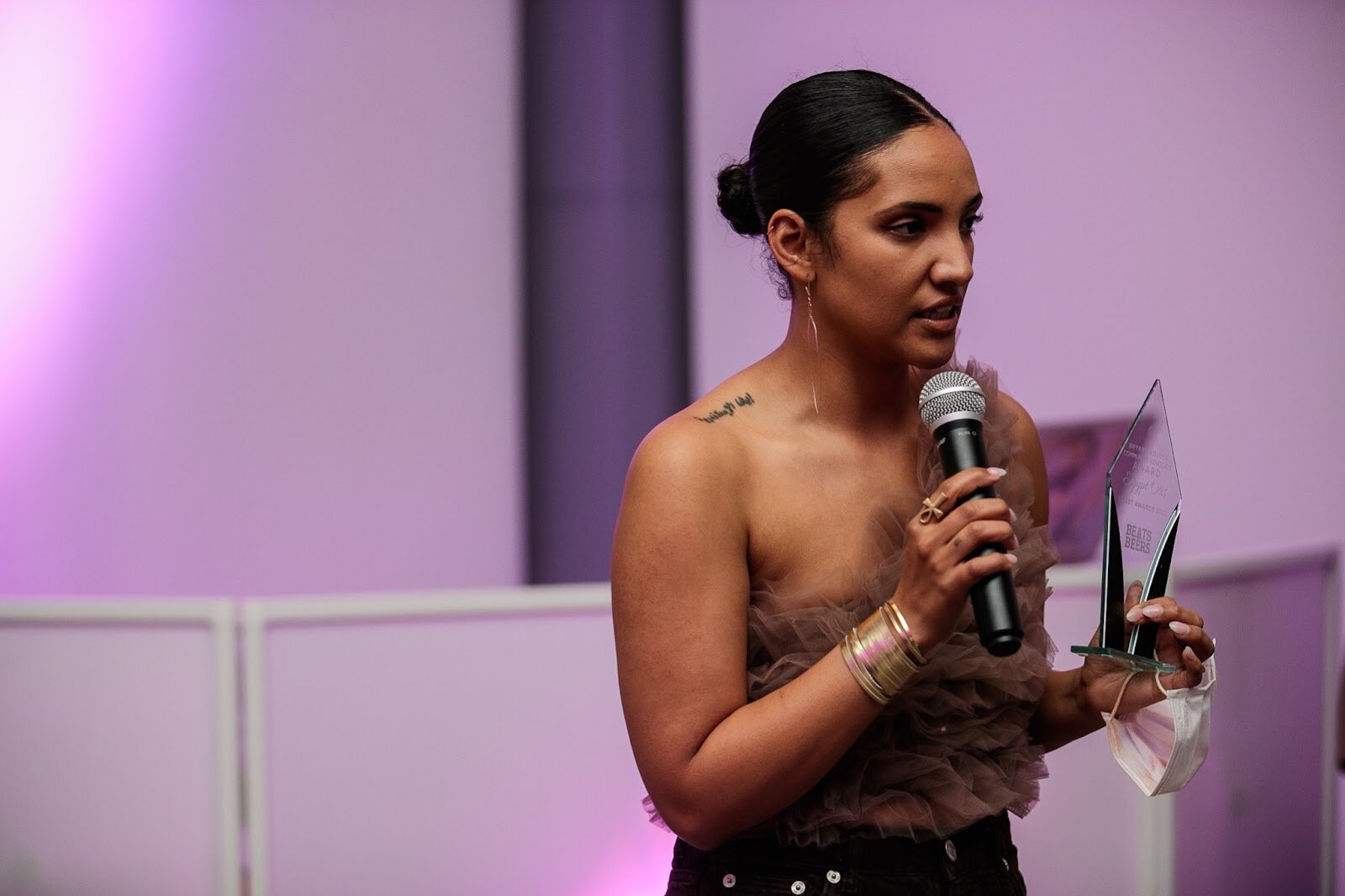 Egypt Otis, owner of Comma Bookstore and Social Hub, gives a speech after receiving the Bryant Nolden Community Advocate Award during the third annual Toast Awards, hosted by Beats x Beers, at the Flint Institute of Arts on Saturday, Dec. 17, 2022. (Jenifer Veloso | Flintside)
