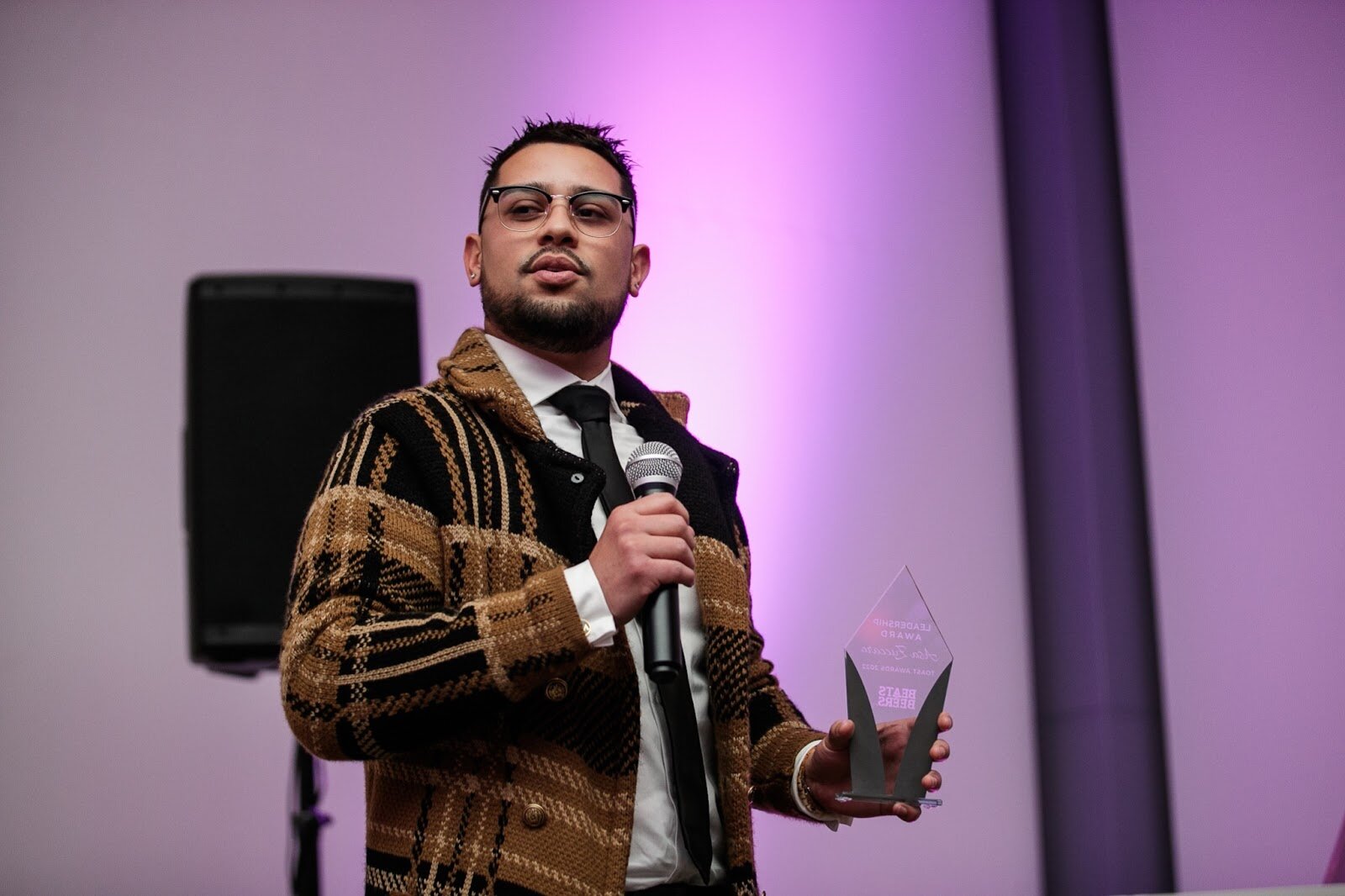 Asa Zuccaro, executive director of the Latinx Technology and Community Center, gives a speech after receiving the Leadership Award during the third annual Toast Awards, hosted by Beats x Beers, at the Flint Institute of Arts on Saturday, Dec. 17, 2022. (Jenifer Veloso | Flintside)
