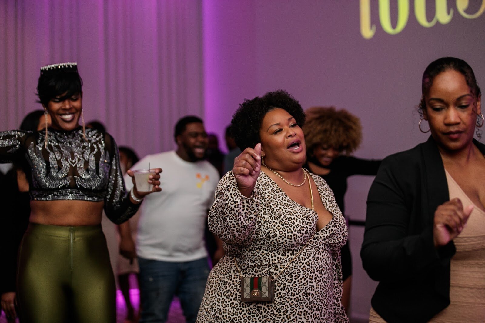 Natalie Kadie, co-owner of Eight Ten Nail Bar, dances with friends during the third annual Toast Awards, hosted by Beats x Beers, at the Flint Institute of Arts on Saturday, Dec. 17, 2022. (Jenifer Veloso | Flintside)
