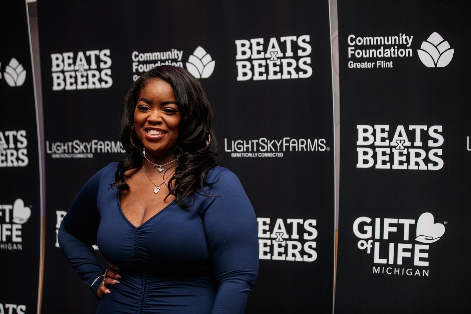 An attendant poses for a portrait during the third annual Toast Awards, hosted by Beats x Beers, at the Flint Institute of Arts on Saturday, Dec. 17, 2022. (Jenifer Veloso | Flintside)
