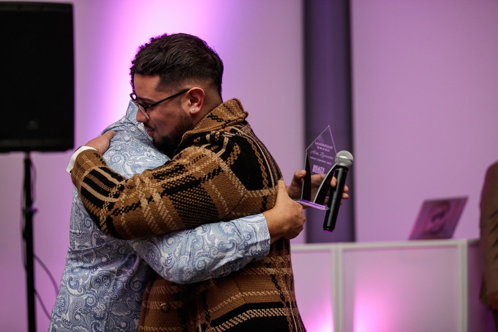 Asa Zuccaro, executive director of the Latinx Technology and Community Center, is welcomed to the stage for his award during the third annual Toast Awards, hosted by Beats x Beers, at the Flint Institute of Arts on Saturday, Dec. 17, 2022. (Jenifer Veloso | Flintside)

