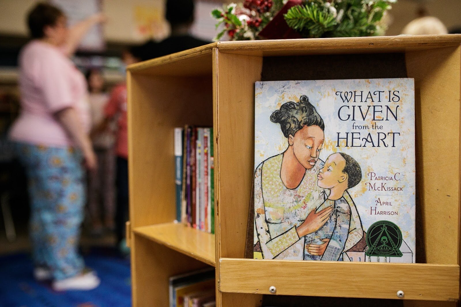‘What is Given from the Heart,” sits on a shelf in Mrs. Gaatz sixth grade classroom during Freeman Elementary’s holiday celebration of literacy and reading comprehension on Friday, Dec. 16, 2022. (Jenifer Veloso | Flintside)
