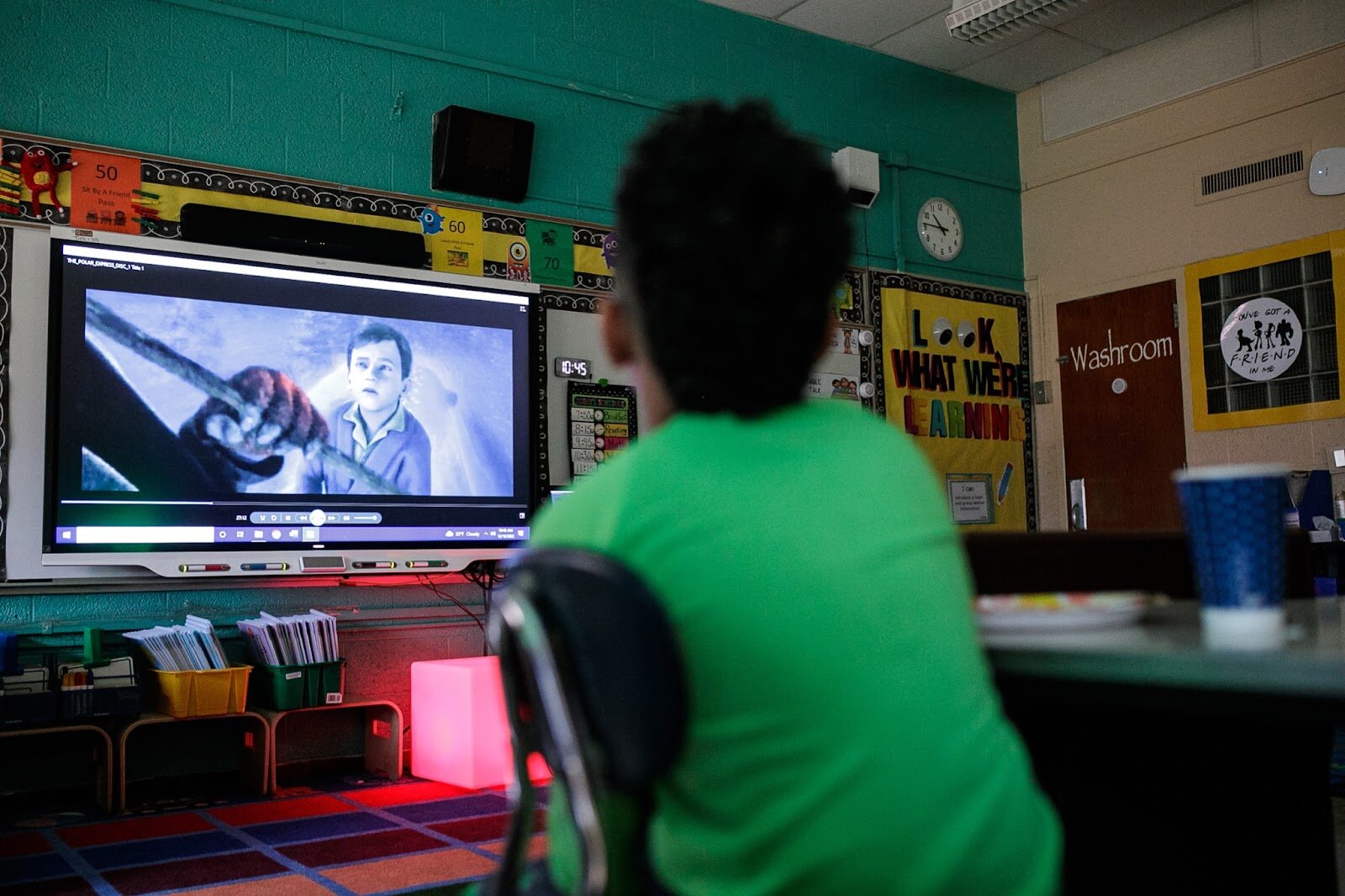 A third-grade Freeman scholar watches The Polar Express during Freeman Elementary’s holiday celebration of literacy and reading comprehension on Friday, Dec. 16, 2022. (Jenifer Veloso | Flintside)
