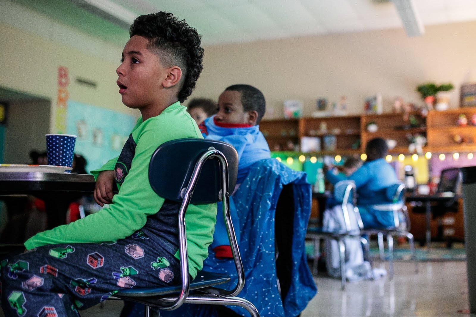 A third-grade Freeman scholar watches The Polar Express during Freeman Elementary’s holiday celebration of literacy and reading comprehension on Friday, Dec. 16, 2022. (Jenifer Veloso | Flintside)
