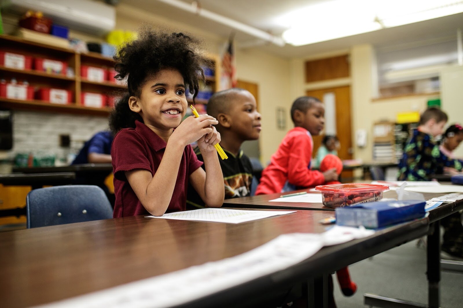 First-grade Freeman scholars listen closely for their names to be called for their Christmas gift bag during Freeman Elementary’s holiday celebration of literacy and reading comprehension on Friday, Dec. 16, 2022. (Jenifer Veloso | Flintside)
