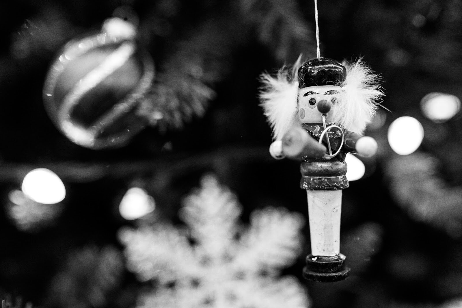 A small nutcracker ornament hangs on a Christmas tree inside the Flint Institute of Music during the College Cultural area’s 37th Annual Holiday Walk in Flint on Tuesday, Dec. 6, 2022. (Jenifer Veloso | Flintside)
