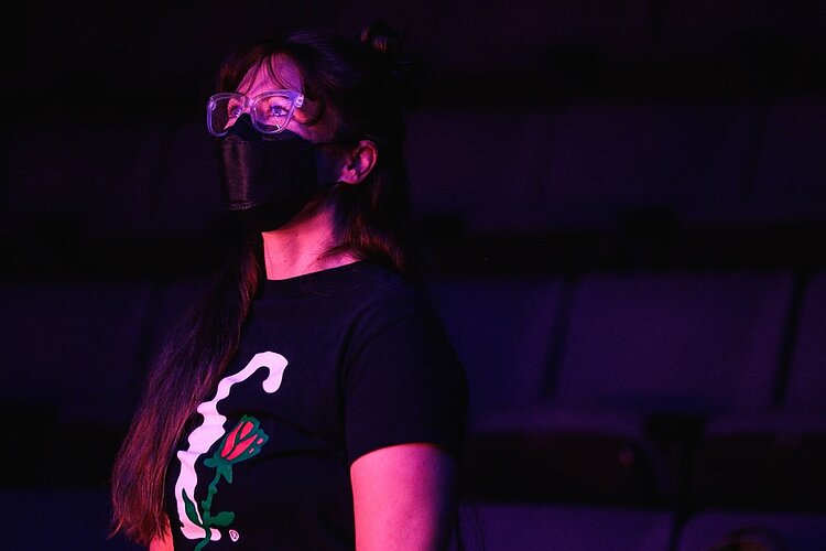 Rhiannon Ragland smiles as she watches the lighting and performance of actors on the set of The Purple Rose's latest play PickleBall on Friday, Sept. 20, 2022. (Jenifer Veloso | Flintside)