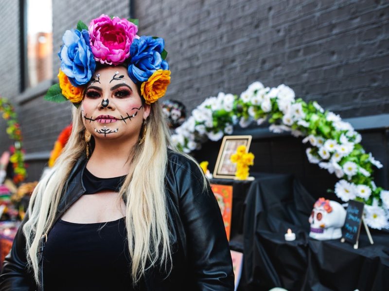 Juliza Murillo, originally from Jalisco, Mexico, poses for a portrait during the Latinx Technology and Community Center's Dia de Los Muertos celebration on Wednesday, Nov. 2, 2022 in downtown Flint.