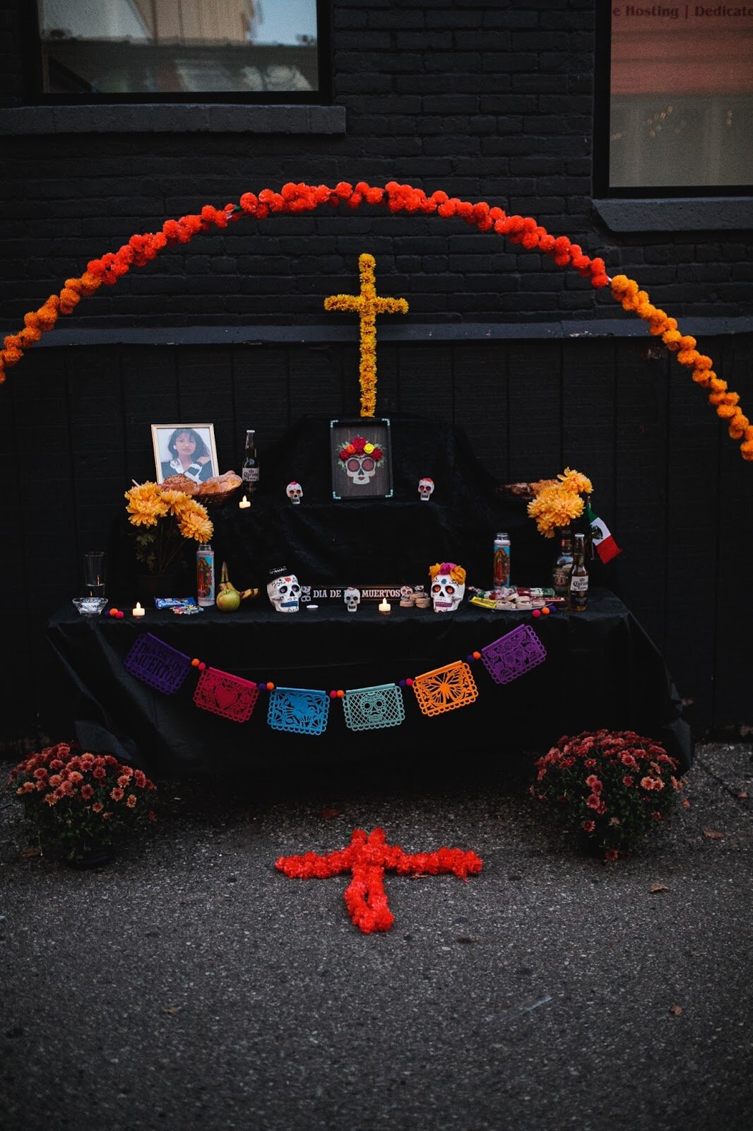 A triple leveled ofrenda sits on display during the Latinx Technology and Community Center's Dia de Los Muertos celebration on Wednesday, Nov. 2, 2022 in downtown Flint. (Jenifer Veloso | Flintside)
