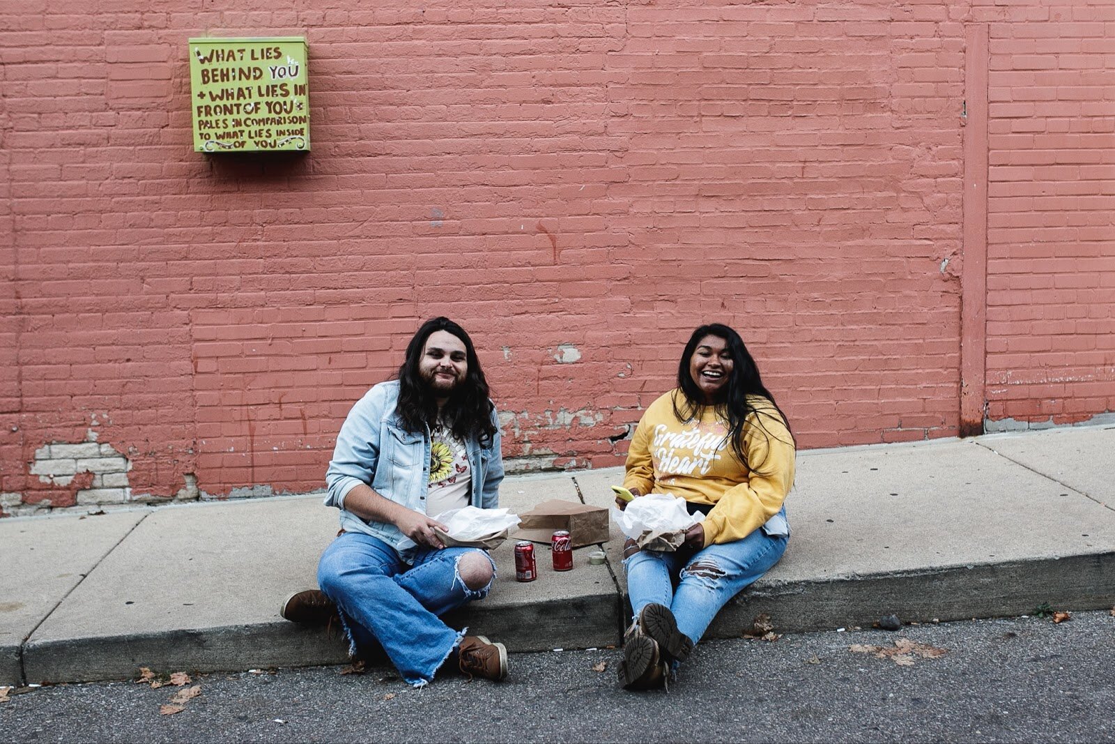 Attendants sit to eat fresly made arepas during the Latinx Technology and Community Center's Dia de Los Muertos celebration on Wednesday, Nov. 2, 2022 in downtown Flint. (Jenifer Veloso | Flintside)