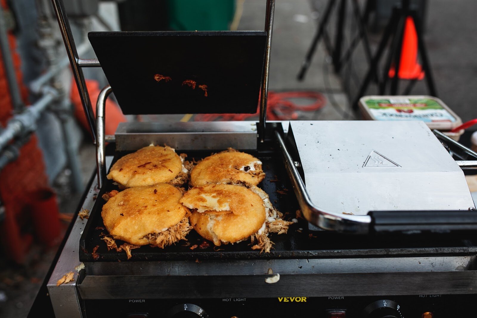 Four freshly made arepas are prepared during the Latinx Technology and Community Center's Dia de Los Muertos celebration on Wednesday, Nov. 2, 2022 in downtown Flint. (Jenifer Veloso | Flintside)