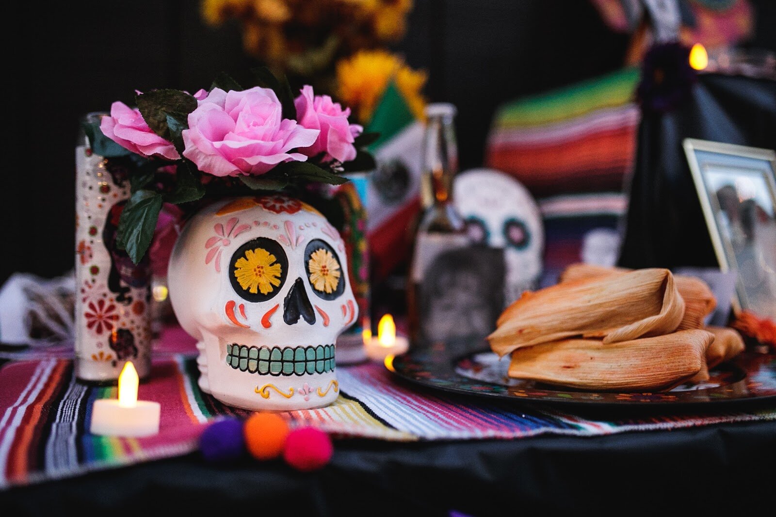 An ofrenda with calaveras, tamales, and photos of deceased loved ones sits on display during the Latinx Technology and Community Center's Dia de Los Muertos celebration on Wednesday, Nov. 2, 2022 in downtown Flint. (Jenifer Veloso | Flintside)