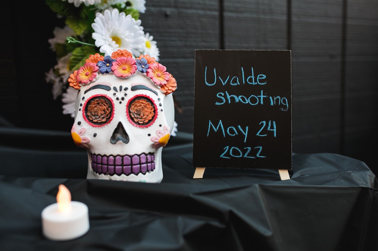 An ofrenda is decorated with a calavera (not pictured: children's art supplies, fresh fruit, toys, and a candle) sits on display in memory of the children killed in the Uvalde shooting during the Latinx Technology and Community Center's Dia de Los Muertos celebration on Wednesday, Nov. 2, 2022 in downtown Flint. (Jenifer Veloso | Flintside)