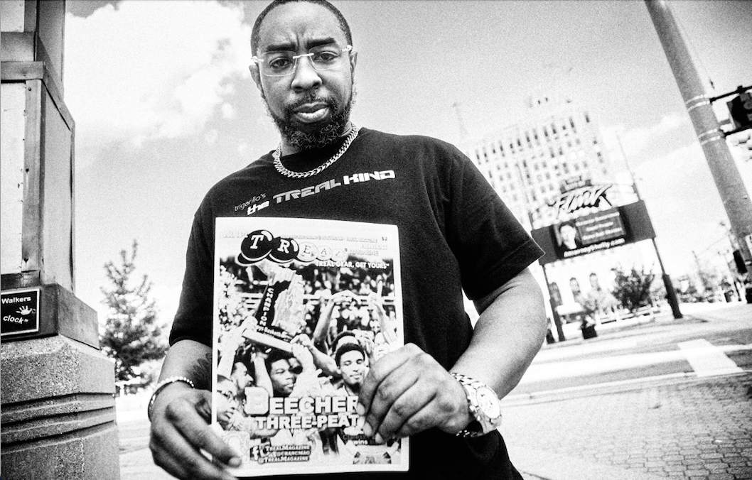 Jones holds a print issue of TREAL Magazine during a Flintside photoshoot with Bryce Mata in downtown Flint.