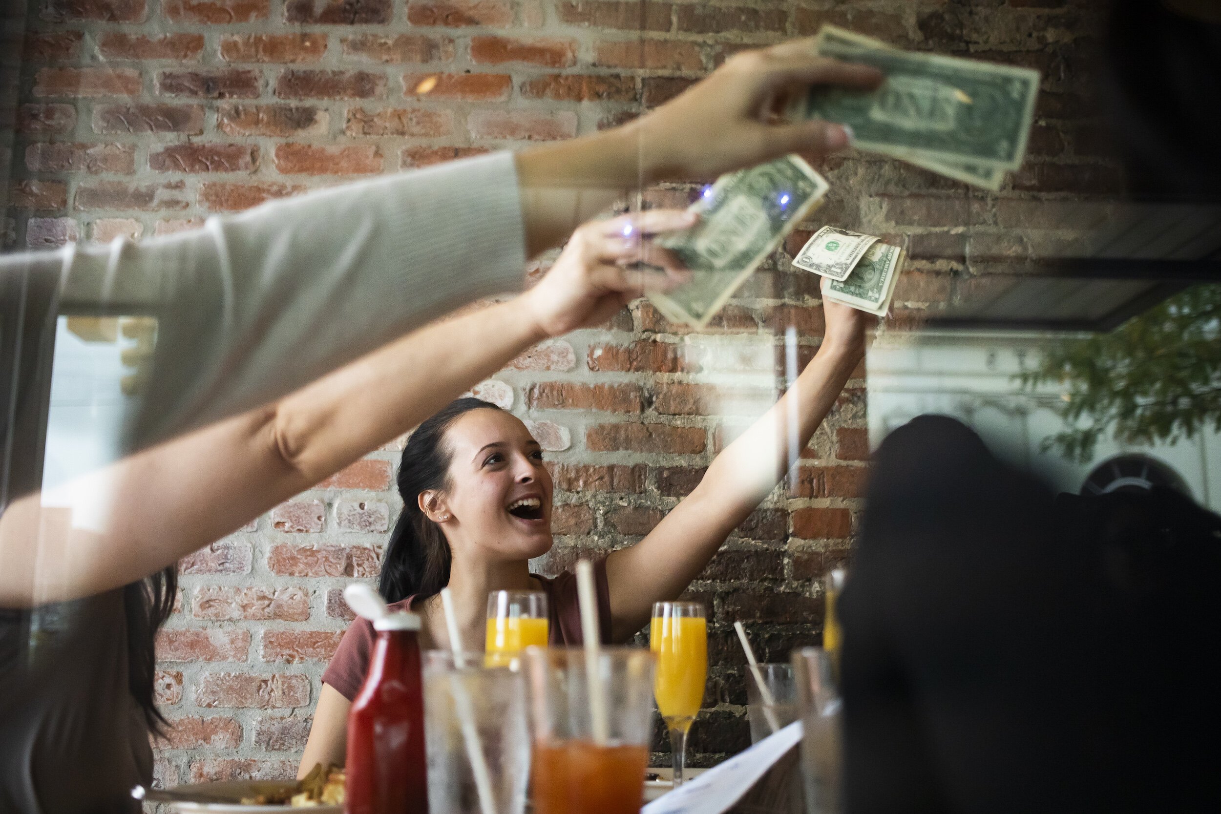 Christine Webber of Goodrich offers a tip for Veronica Scott during a Michigan Drag Brunch performance Sunday, Sept. 25, 2022 at 501 Bar and Grill in downtown Flint.