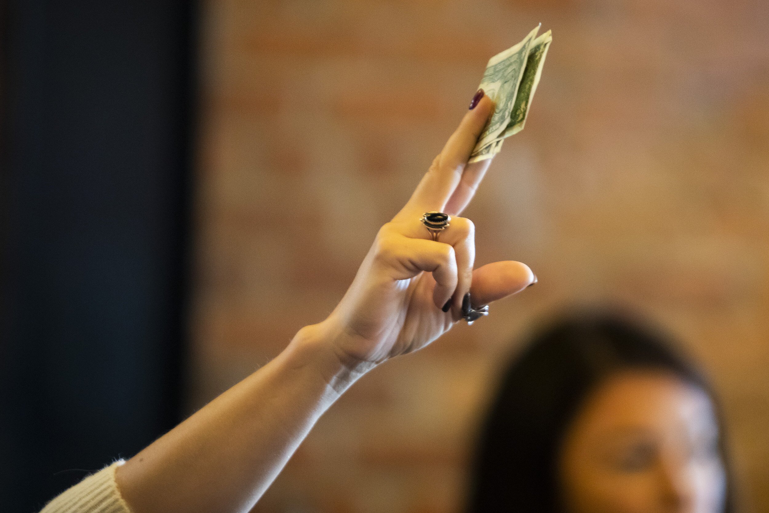 Guests offer cash tips during a Michigan Drag Brunch performance Sunday, Sept. 25, 2022 at 501 Bar and Grill in downtown Flint.