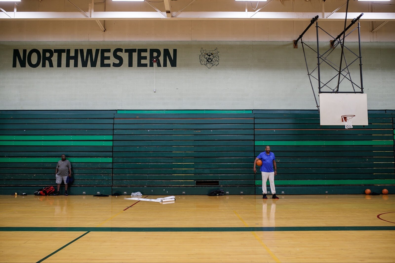 Earl Cureton watches as attendants line up for drills during Hami Day Camp at Flint Northwestern High School on Friday, Aug. 27, 2022. (Jenifer Veloso | Flintside.com)
