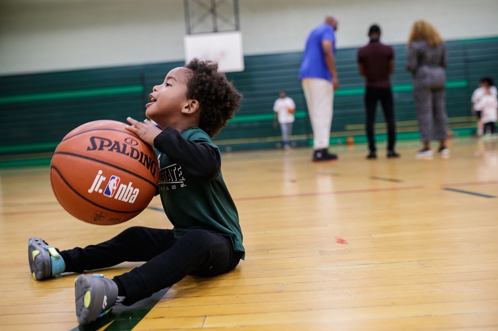 Jaxx Jones plays with a basketball during Hami Day Camp at Flint Northwestern High School on Friday, Aug. 27, 2022. (Jenifer Veloso | Flintside.com)
