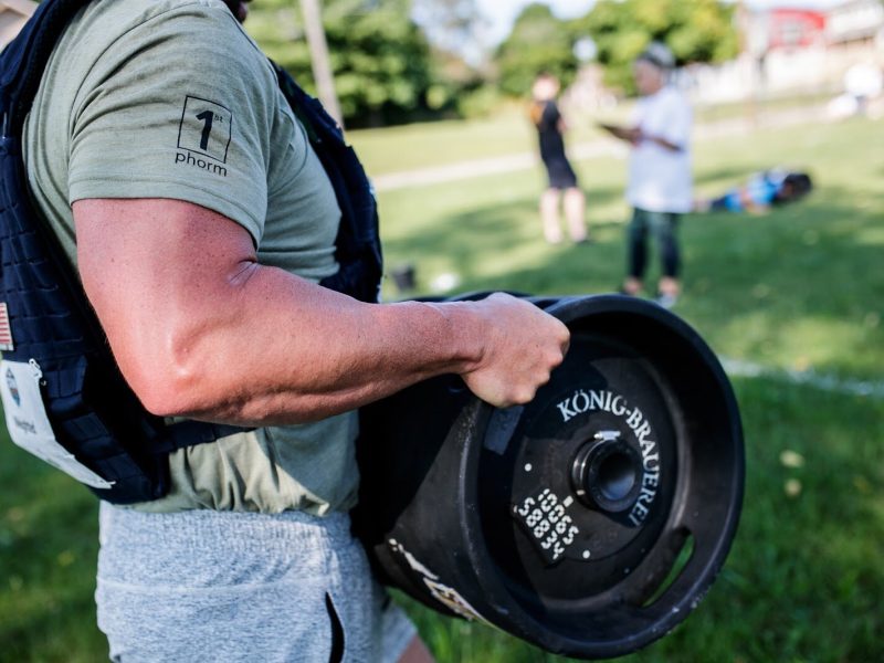 Weighted Challenge participant Donald Stilson lifts a 55-pound keg for the CrossFlint 5K Challenge during the 45th annual Crim Festival of Races in downtown Flint.
