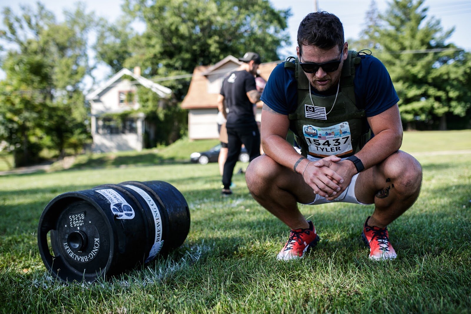 Tyler Dipzinski catches his breath in between burpees for the CrossFlint 5K Challenge during the 45th annual Crim Festival of Races on Saturday, Aug. 27, 2022 in downtown Flint. (Jenifer Veloso | Flintside.com)
