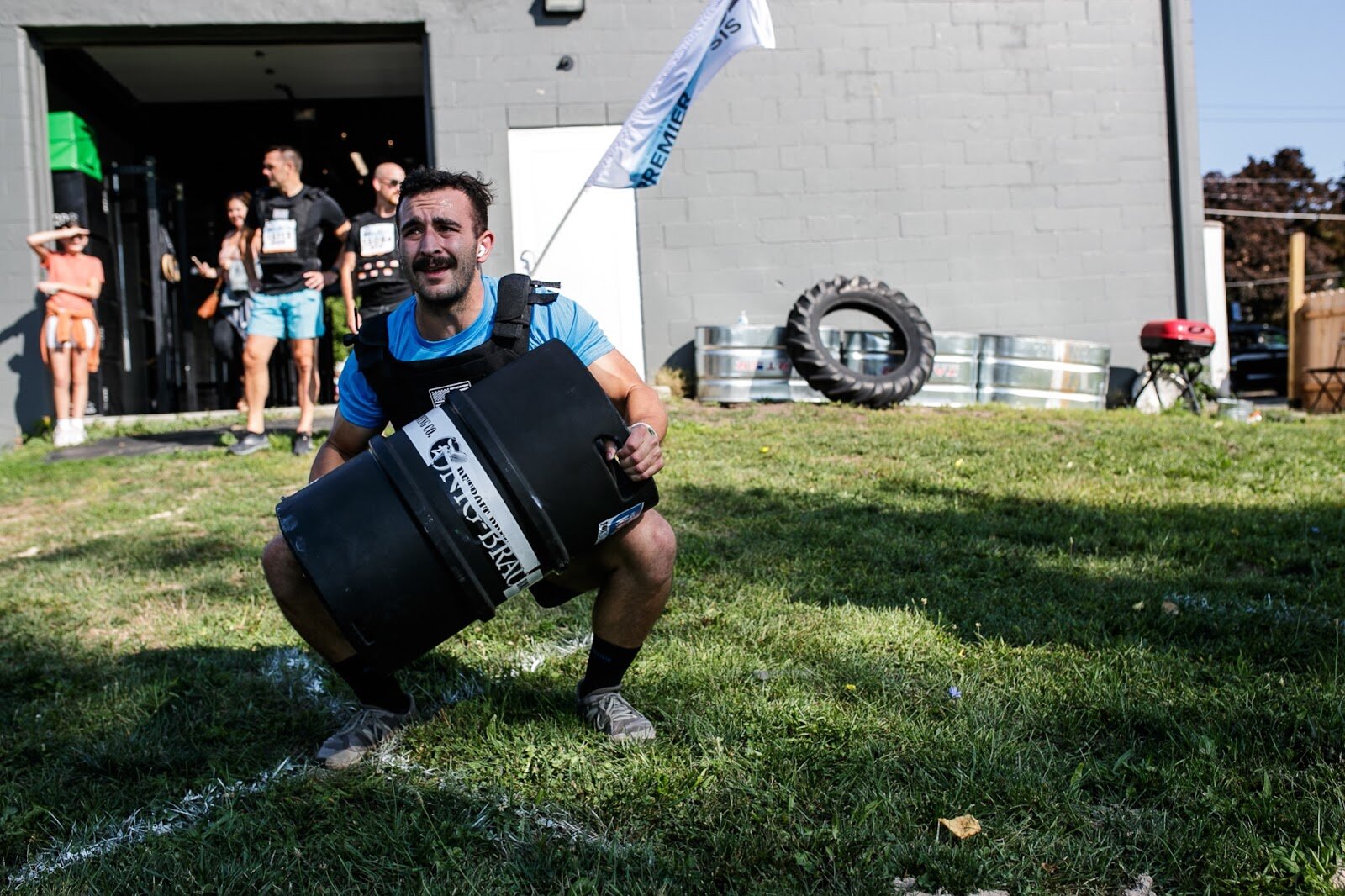 John Lagaski prepares to lift a keg for the keg thrusters movement for the CrossFlint 5K Challenge during the 45th annual Crim Festival of Races on Saturday, Aug. 27, 2022 in downtown Flint. (Jenifer Veloso | Flintside.com)
