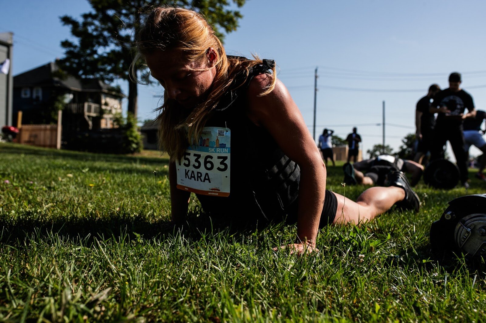 Kara Dahlberg completes a round of burpees over a keg for the CrossFlint 5K Challenge during the 45th annual Crim Festival of Races on Saturday, Aug. 27, 2022 in downtown Flint. (Jenifer Veloso | Flintside.com)
