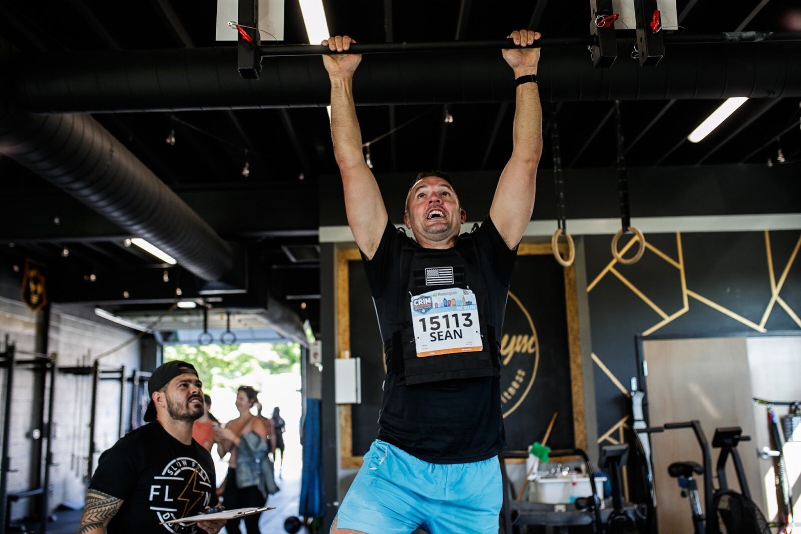 A Weighted Challenge participant completes a pull-up for the CrossFlint 5K Challenge during the 45th annual Crim Festival of Races on Saturday, Aug. 27, 2022 in downtown Flint. (Jenifer Veloso | Flintside.com)
