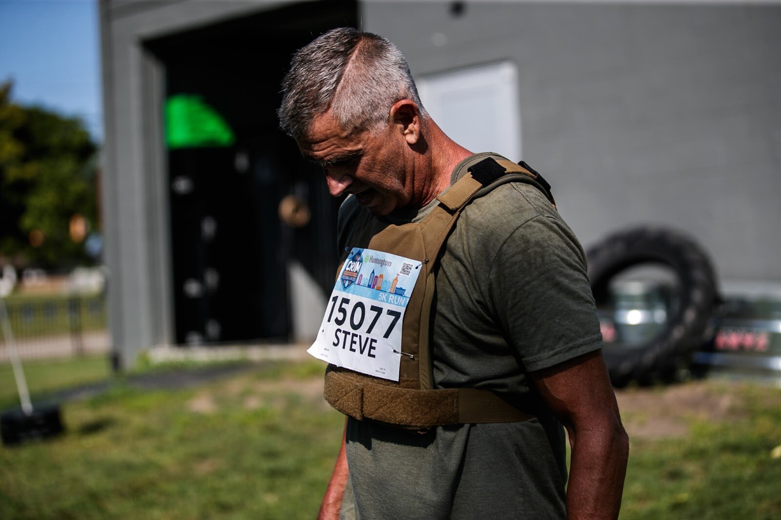 A Weighted Challenge participant takes a breath in between keg thrusters at the CrossFlint 5K Challenge during the 45th annual Crim Festival of Races on Saturday, Aug. 27, 2022 in downtown Flint. (Jenifer Veloso | Flintside.com)
