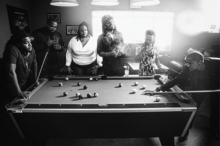 In good company, Jeff Skigh shares a moment around the pool table inside King's Cigar Lounge in Flint.