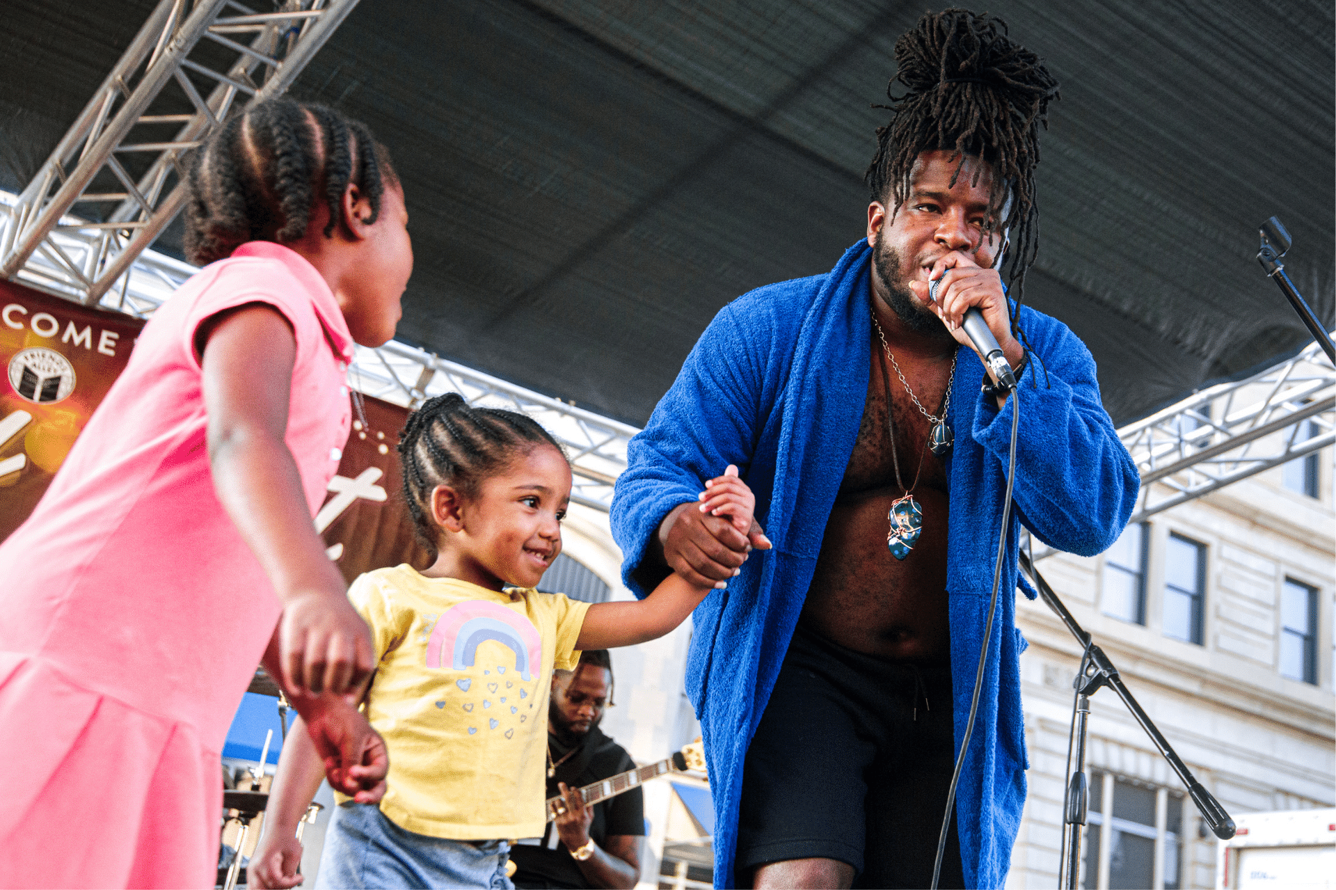 Skigh welcomes a pair of young fans on stage during his live set at Alley Fest in Flint.