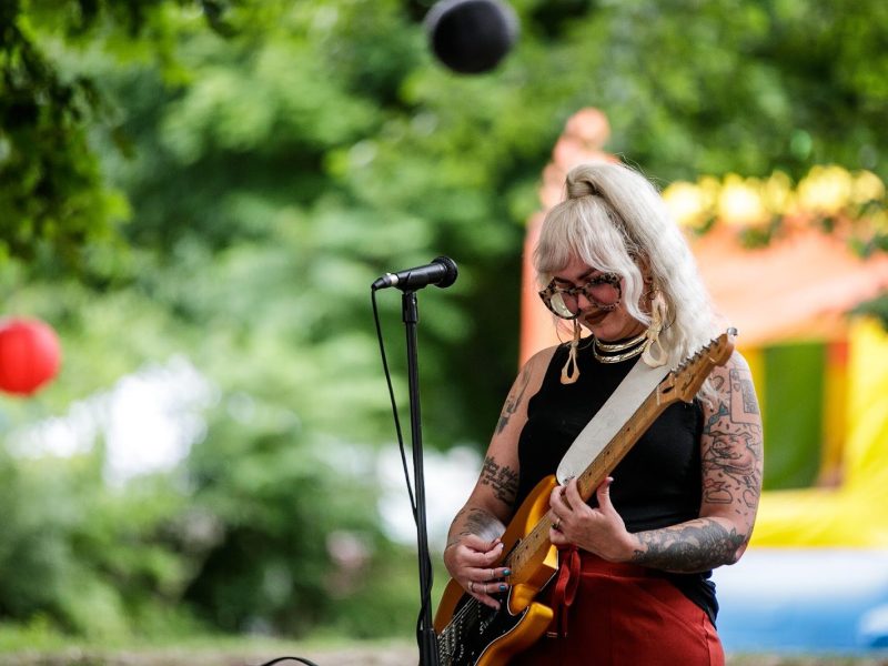 Polly, local musician, plays music during Porch Fest on Friday, July 15, 2022.